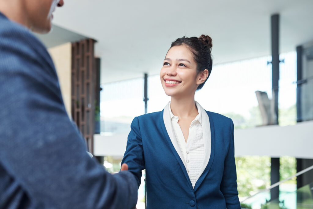 Confident business interaction with a handshake, showcasing communication skills essential for sales representative jobs.