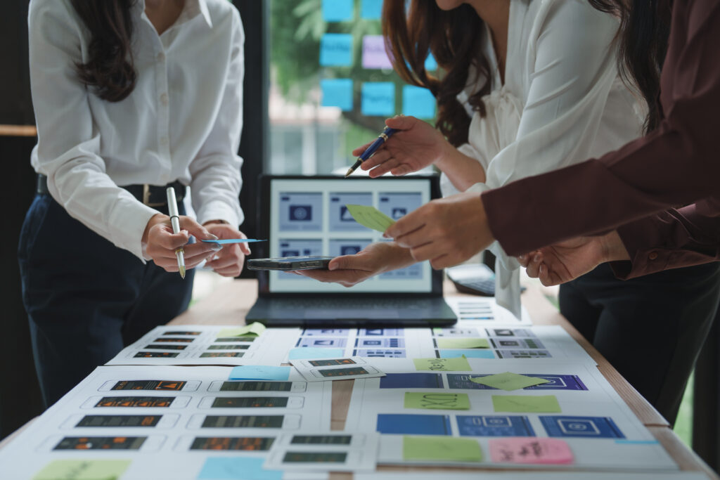 Team reviewing visuals and ideas, highlighting teamwork and innovation in brand development.