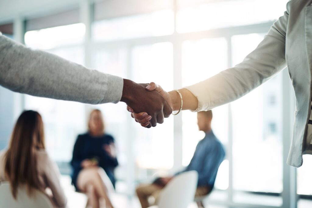 Two business partners strengthening a client relationship through collaboration and meaningful communication.